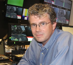 Pixotope Creative Engineer Patrick Ford dressed in a blue shirt looking into camera 
