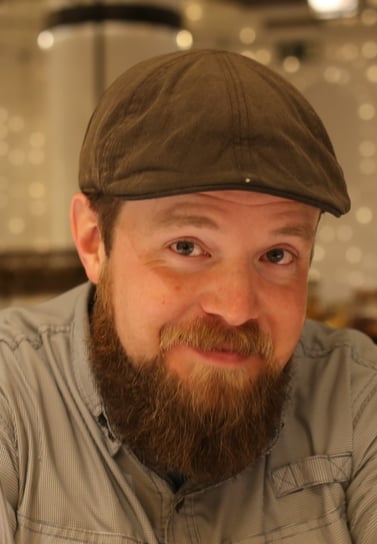 Portrait photo of a man with beard and a hat