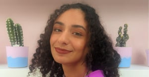 Close-up of Pixotope UI/UX designer Farah Abdelwahab dressed in purple shirt smiling into camera