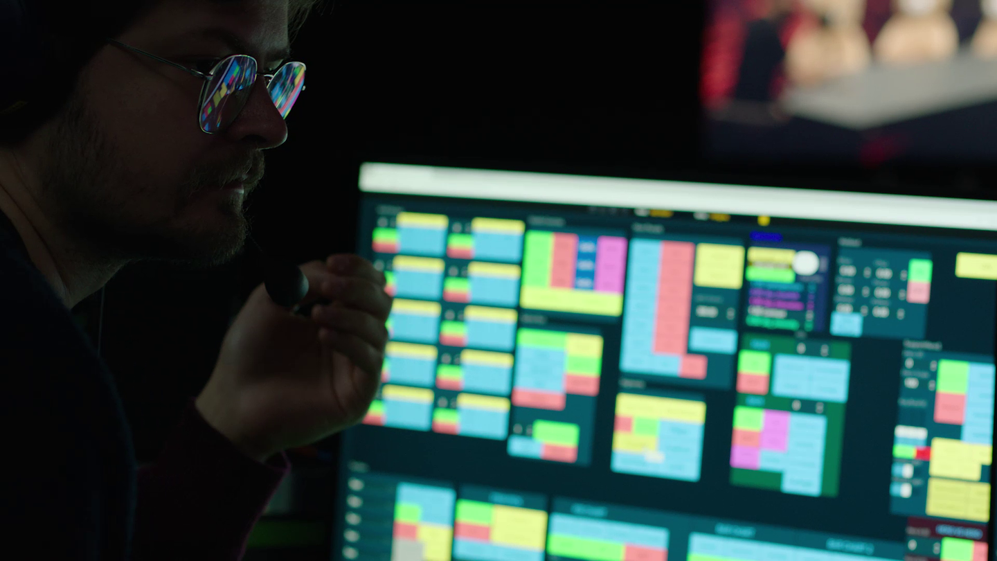 Man during the production of Dota 2 tournament setting up Pixotope software