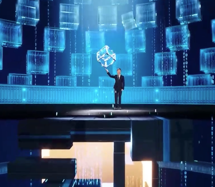 Main in a black suit standing in a virtual studio holding a virtual cube