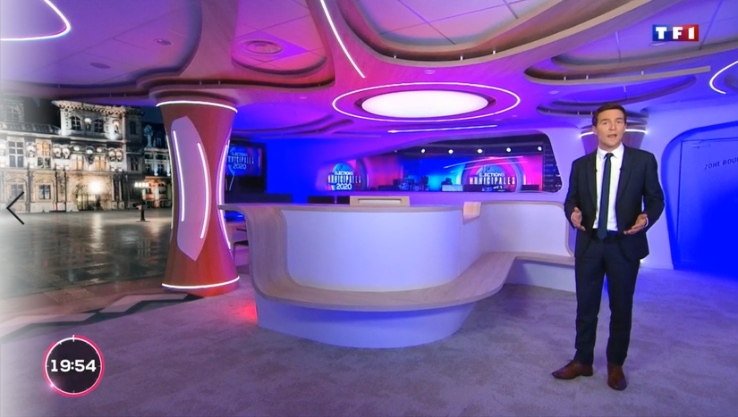 Host in a suit standing in a virtual studio