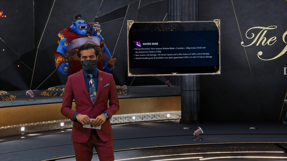 Host in a dark red suit stands in the virtual studio powered by Pixotope.