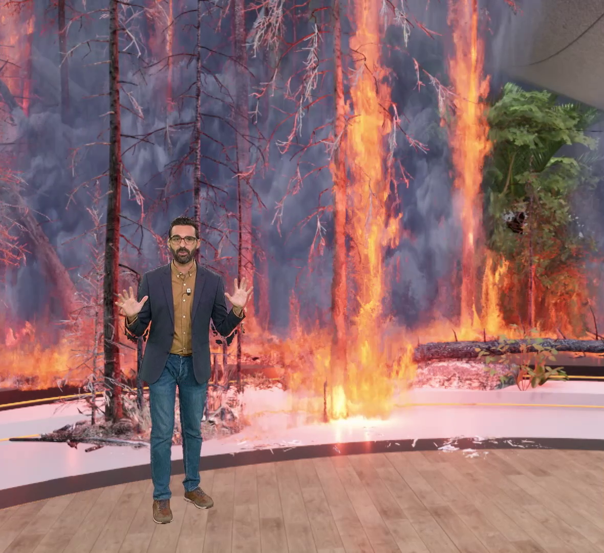 Male host of primetimeshow standing in a virtual studio portraying fire in the woods